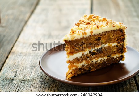 carrot cake with walnuts, prunes and dried apricots on a dark wood background. tinting. selective focus Royalty-Free Stock Photo #240942904