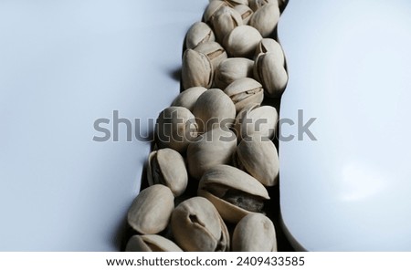 Heap of pistachios in a line. Healthy diet background