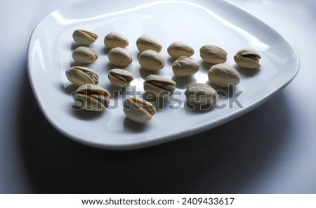 Pistachios on a plate in a geometrical shape. Elegant