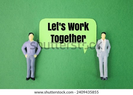 miniature people and colored paper with the words Let's work together. team concept