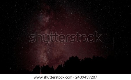 Above the sheer Rupal Face of Nanga Parbat, the ninth highest peak on Earth, the Milky Way stretches its luminous arms in this mesmerizing astrophotograph. Royalty-Free Stock Photo #2409439207