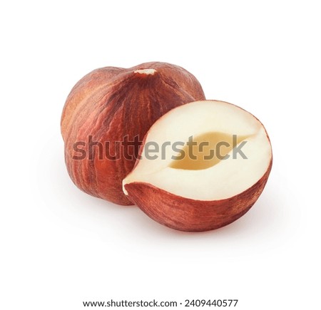 Isolated raw hazelnuts. Whole and a half of hazelnut isolated on white background Royalty-Free Stock Photo #2409440577