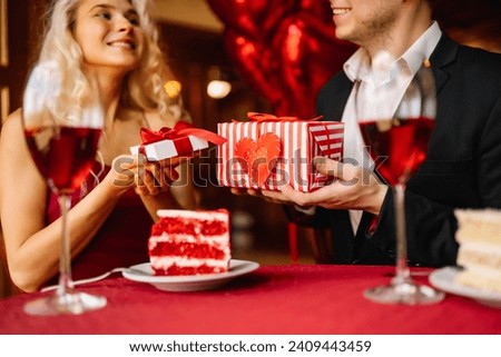Love, romance, valentine's day. A couple in love in a cafe exchanges gifts and spends time together. Concept of relationships, holiday, surprise.