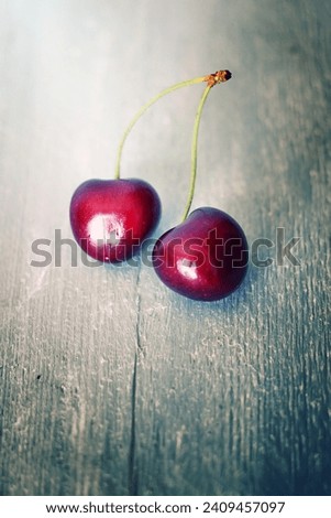 Photo of ripe cherries on wooden background
