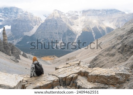 Tourists enjoying the beautiful scenery of Canadian Rockies landscape. View of the Paradise Valley, Grand Sentinel, Sentinel Pass. Banff National Park, Alberta, Canada. Royalty-Free Stock Photo #2409462551