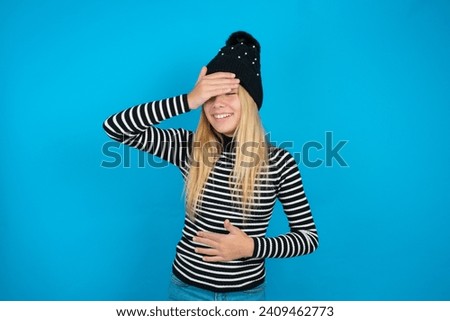 beautiful caucasian teen girl knitted  hat and striped T-shirt Touching forehead for illness and fever, flu and cold, virus sick.