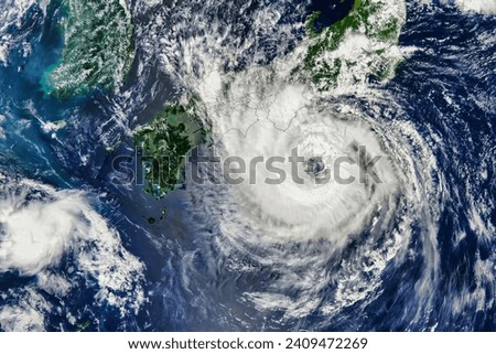 Typhoon Lan Lashes Japan. The island nation braced for the second major storm in less than a week. Elements of this image furnished by NASA. Royalty-Free Stock Photo #2409472269