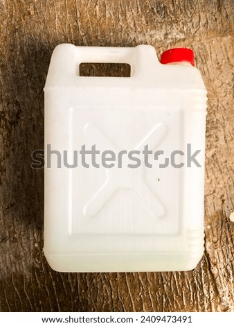 White jerry cans on a cement wall background