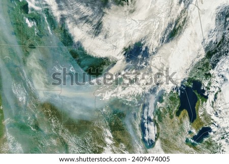 Smoke Blankets the Upper Midwest. Smoke from the fires in Canada polluted the air and shrouded the Minneapolis skyline. Elements of this image furnished by NASA.