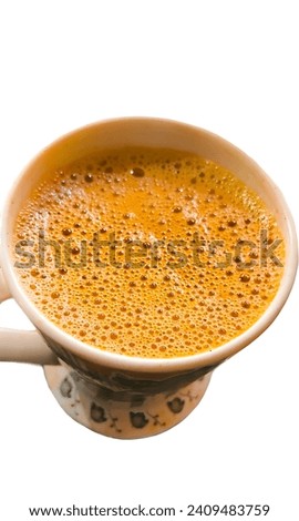 Pakistani chai with white background, "chai," is a fragrant blend of black tea, milk, and spices such as cardamom and cloves. Served hot, it offers a comforting, creamy, and aromatic experience.