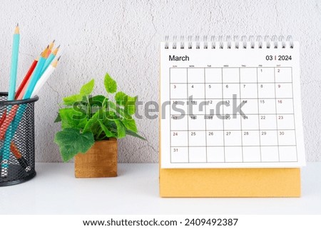March 2024 Desk Calendar with pencil on white table.