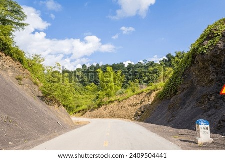 The roads in the green mountains in the middle of the forests, in Asia, in Vietnam, in Tonkin, in Dien Bien Phu, in summer, on a sunny day.