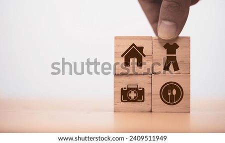 Four basic material for human being include House food cloth and medicine print screen on wooden block cube. Royalty-Free Stock Photo #2409511949