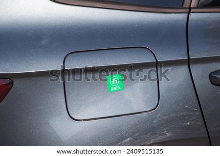 Benzin 95 sticker on the tank of a passenger car.