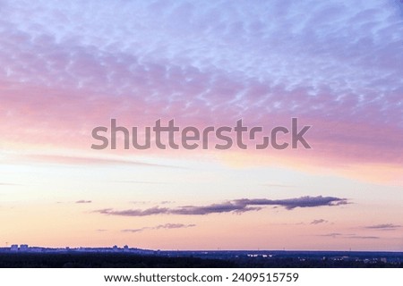 Beautiful pink cirrus clouds on a background of the evening sky. Concept for desktop background, natural texture, nature. Kyiv (Kiev), Ukraine, Europe.