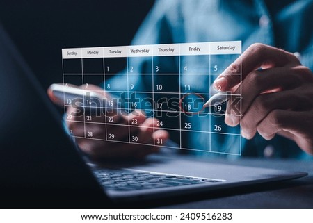 Time management concept. Businessman use laptop to manage time for effective work. Calendar on the virtual screen interface. Highlight appointment reminders and meeting agenda on the calendar. 