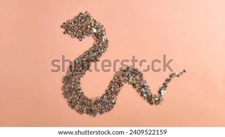 The New Year's symbol is a snake made of shiny stars. 2025