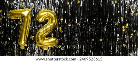 Gold foil balloon number number 72 on a background of black tinsel decoration. Birthday greeting card, inscription seventy-two. Anniversary event. Banner. copy space. Royalty-Free Stock Photo #2409523615