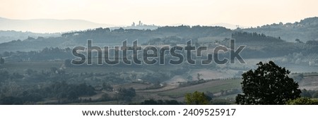 Typical Tuscan landscape near San Gimignano, Italy Royalty-Free Stock Photo #2409525917
