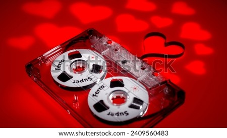 Klaipeda, Lithuania - Dec 27, 2023: Valentines day background banner - audio cassette on red background with red hearts - concept love.