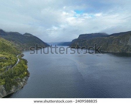 A Aerial picture of a Fjord in the early spring near Stavanger, Norway with a boat sailing in the Fjord. 