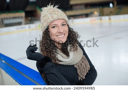 girl smiling while skating in an ice rink