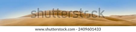 Panorama of desert landscape in Africa with sand dunes in Namib desert, Namibia. Nature background of sandy hills with soft lines and copy space for your design of header or banner, wide format. Royalty-Free Stock Photo #2409601433