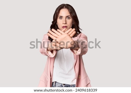 Young Caucasian woman in a studio setting doing a denial gesture