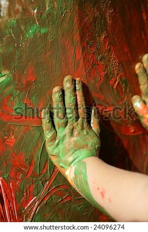 Children artist hands painting colorful with her fingers