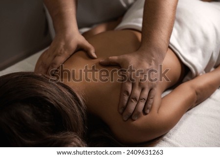 Chiropractor masseur doing exam back of lady, rehabilitation massage in medic room, healthy lifestyle. Rehab massage back for woman at clinic. Wellness medicine massaging concept. Copy ad text space