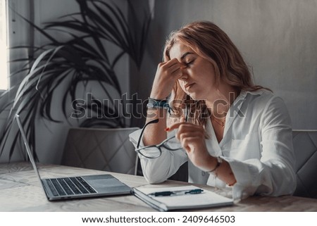 Stressed tired woman in pain having strong terrible headache attack after computer laptop study, fatigued exhausted girl suffering from chronic migraine massaging temples to relieve head ache tension Royalty-Free Stock Photo #2409646503