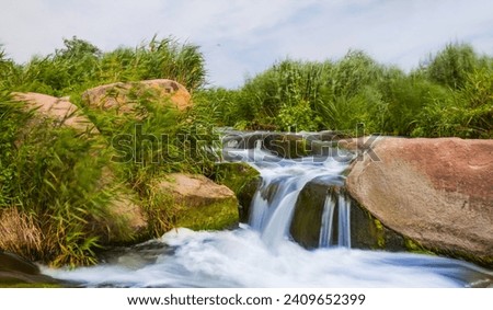 small waterfall rushing over a stones