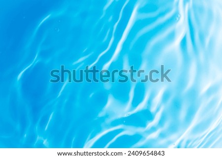 Blue water surface,Transparent blue clear water surface texture with ripples, splashes and bubbles. Abstract nature background Water waves in sunlight. Cosmetic moisturizer micellar toner emulsion. 