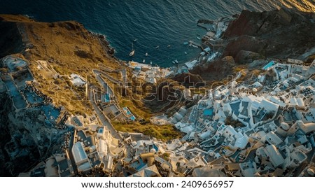 Aerial view of Santorini's cliffside architecture during sunset.