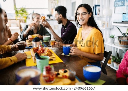 Young group of student friends having breakfast at coffee shop. People, food and beverage concept Royalty-Free Stock Photo #2409661657