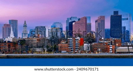 Boston city skyline at sunset over the Charles River in Massachusetts, USA, a vibrant cityscape of modern metropolis