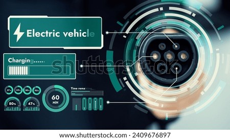Focus EV charger pointing in front of camera display smart digital battery status hologram with blur businessman background. EV car charger using alternative clean energy reducing CO2 emission. Peruse