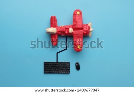 A picture of keyboard, mouse, line and aircraft miniature on blue background. Search the flight concept.