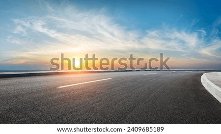 Asphalt highway road and sky clouds at sunset