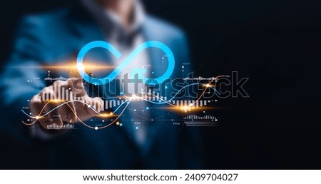 Business planning and strategy concept. Businessman touching with virtual infinity symbol and business profit revenue growth graph for Circular economy with infinite concept. Royalty-Free Stock Photo #2409704027