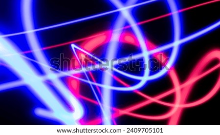 Abstract electric line neon colorful gradient black background. Concept three color red blue light trail slow shutter speed.