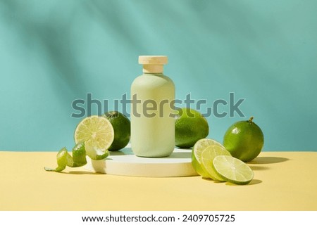 Front view of an unlabeled cosmetic bottle placed on a white podium with fresh lemons around. A pastel background is suitable for advertising and branding. Royalty-Free Stock Photo #2409705725