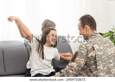 military father and two daughters at home