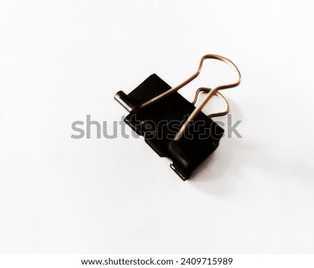 black paperclip on white background
