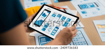 Panorama banner of startup UX developer or company employee design user interface or UI prototype for mobile application or website software with software display on tablet screen in office. Synergic