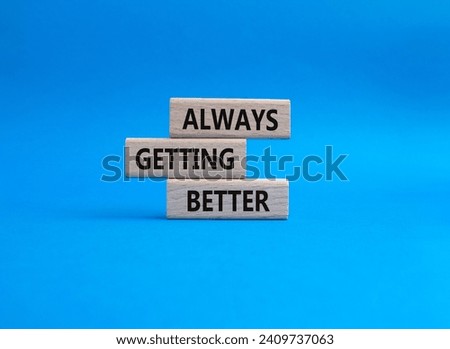 Always getting better symbol. Wooden blocks with words Always getting better. Beautiful blue background. Business and Always getting better concept. Copy space.