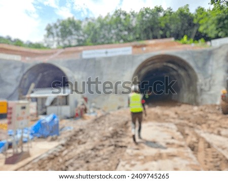 Blurred image of an engineer walking in to inspect the drilling of a railway tunnel:Use for website banner background,backdrop