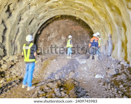 Blurred picture of engineers inspecting the drilling of a railway tunnel:Use for website banner background,backdrop