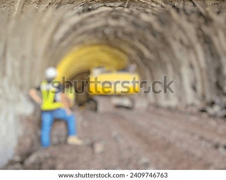 Blurred image of a mechanic operating a machine digging a railway tunnel:Use for website banner background,backdrop