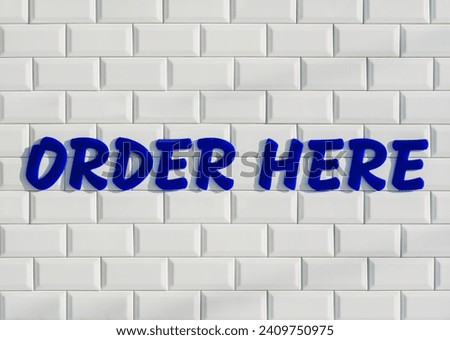 Order here Sign Type on white wall tile Retro style Shop retail Signage design